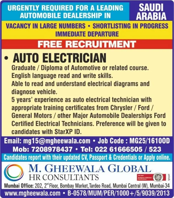 Auto Electrician working on vehicle electrical system in workshop
