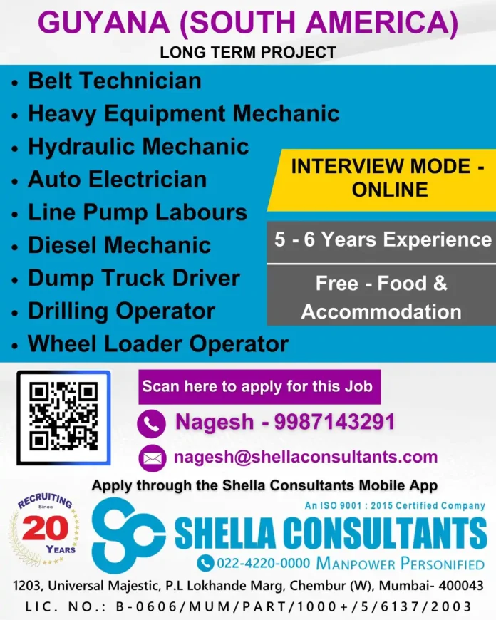 Heavy equipment mechanic working on machinery at construction site in Guyana