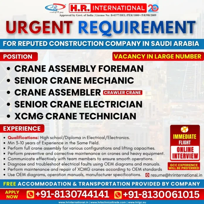 Crane technician working on heavy construction equipment in Saudi Arabia