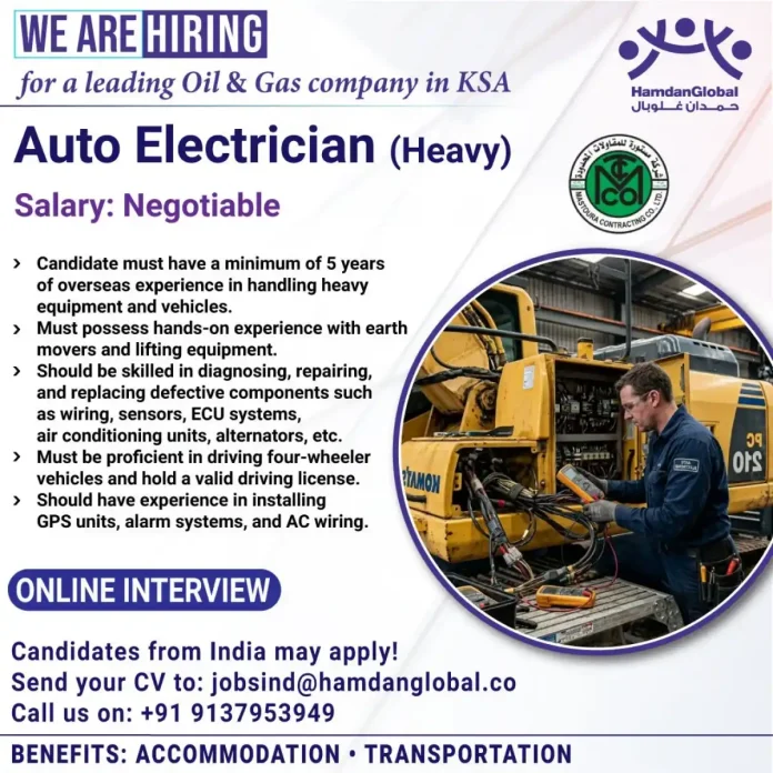 Auto Electrician working on heavy equipment electrical system in workshop