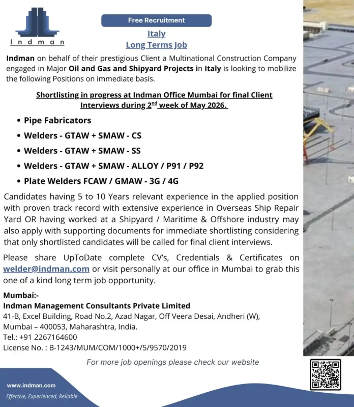 Welder working on industrial pipeline at construction site in Italy