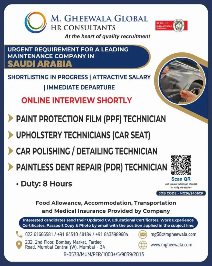 Skilled automotive technician applying paint protection film on a car