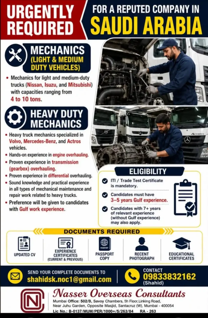 Heavy duty mechanic overhauling engine of Volvo truck in workshop