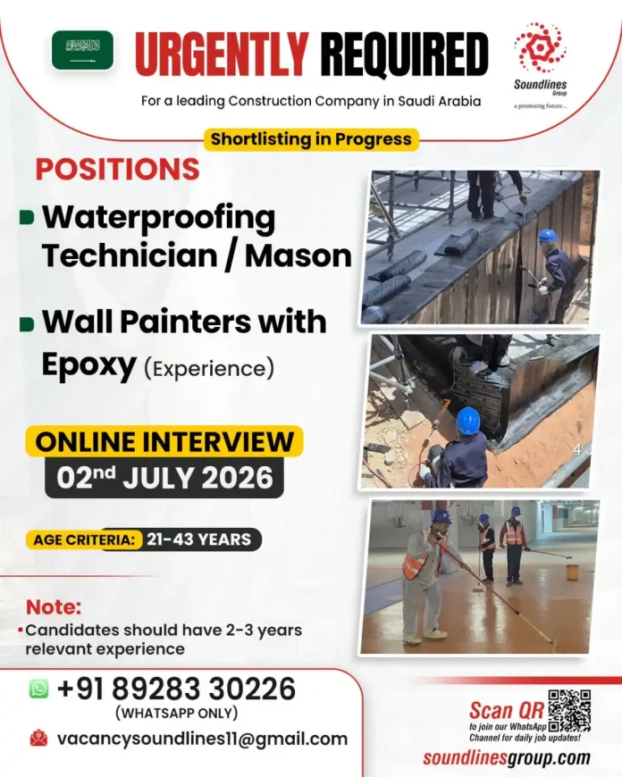 Construction worker applying waterproofing on building rooftop